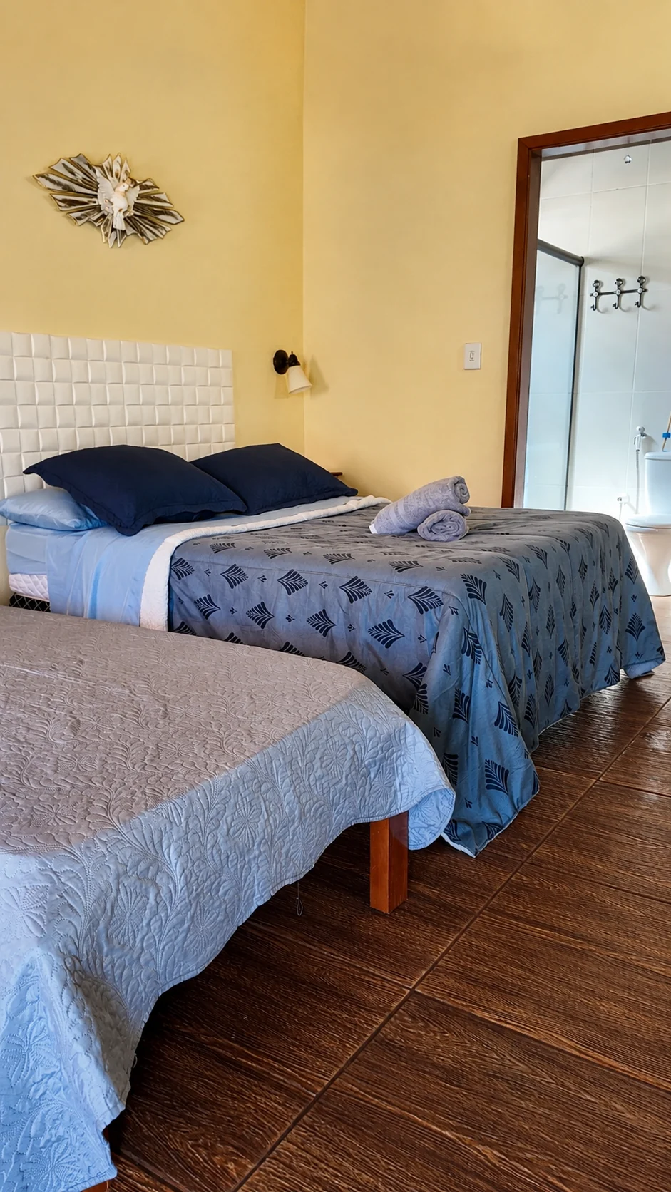 Quarto de chalé com duas camas e roupa de cama azul